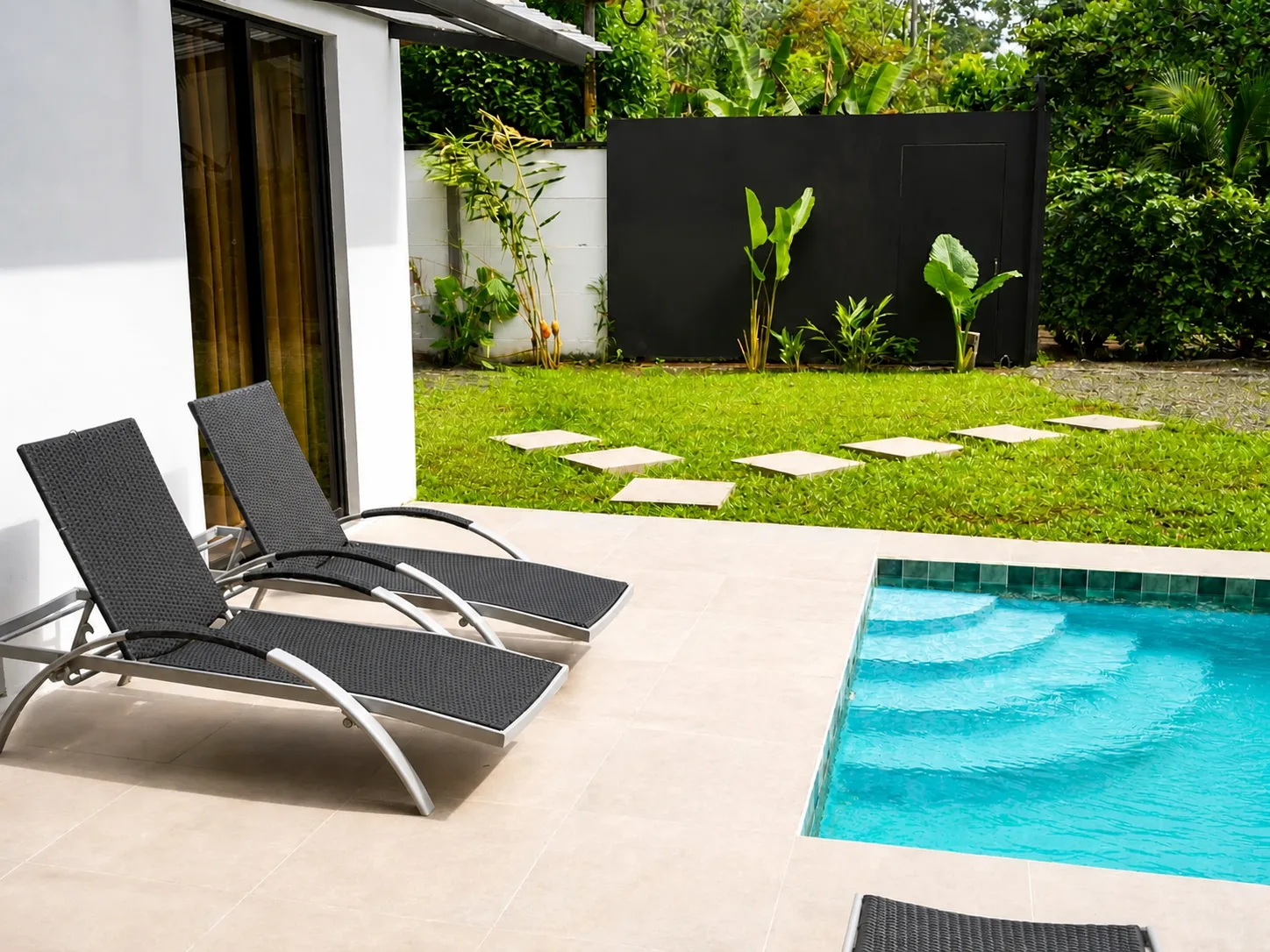 Villa Isora pool loungers and tropical garden